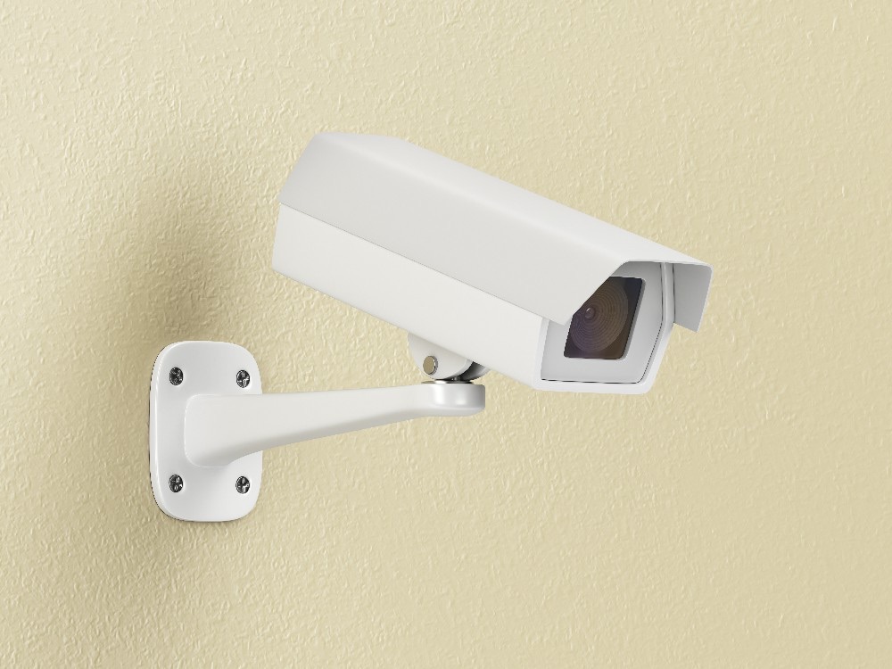 A wall-mounted outdoor security camera