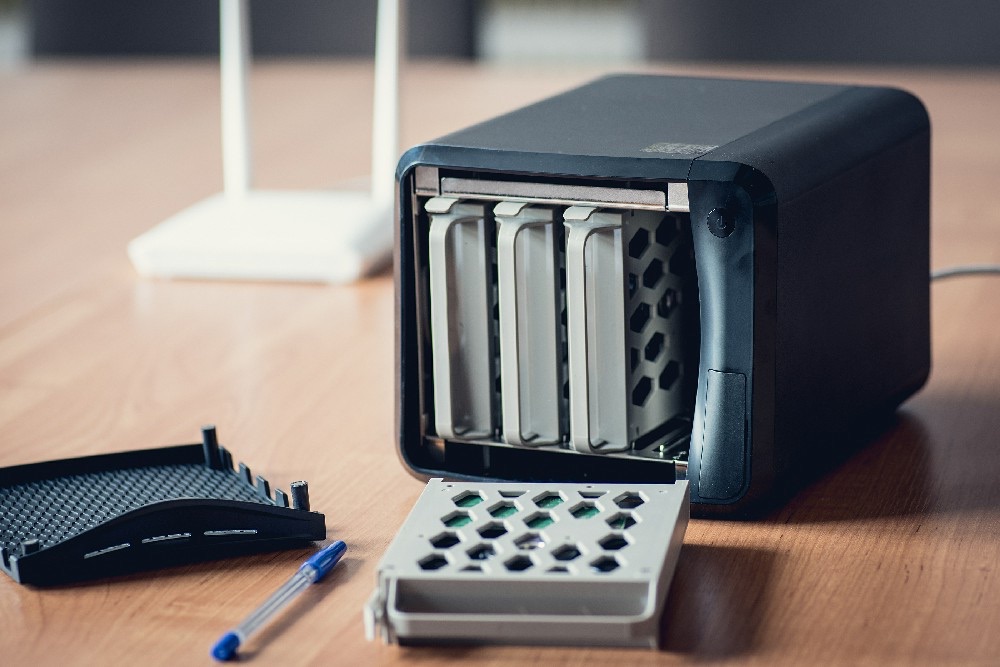 A desktop network attached storage unit with its drive bays exposed